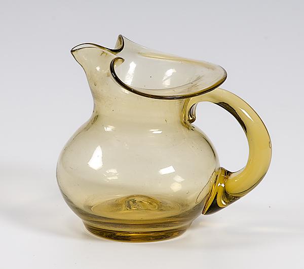 Appraisal: COLORED BLOWN GLASS PITCHER Late th century amber blown glass