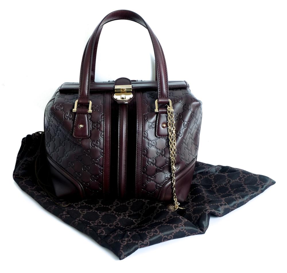 Appraisal: GUCCI EMBOSSED OXBLOOD LEATHER PURSEGucci embossed leather with interlocking G