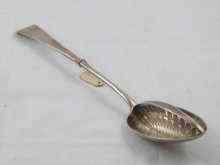 Appraisal: A Georgian silver strainer serving spoon with fixed central strainer