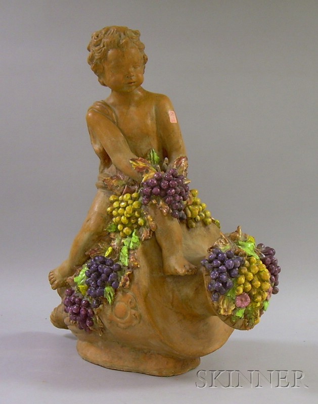 Appraisal: Glazed Terra-cotta Cherub with Grapes and Urn Garden Figure ht