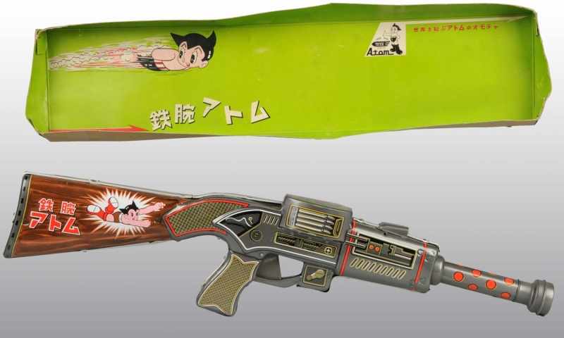 Appraisal: Tin Astro Boy Superhero Rifle Battery-Op Toy Description Japanese Working