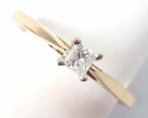 Appraisal: DIAMOND AND TEN KARAT GOLD SOLITAIRE RING set with a