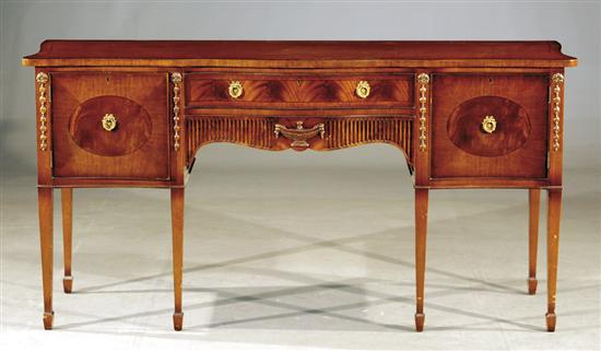 Appraisal: Adam style carved mahogany serpentine sideboard shaped and crossbanded top