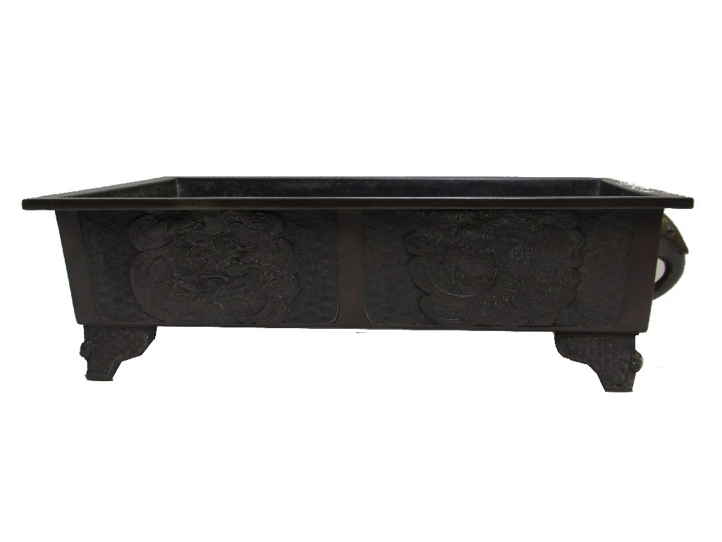 Appraisal: A Chinese bronze rectangular two handled planter cast with dragons