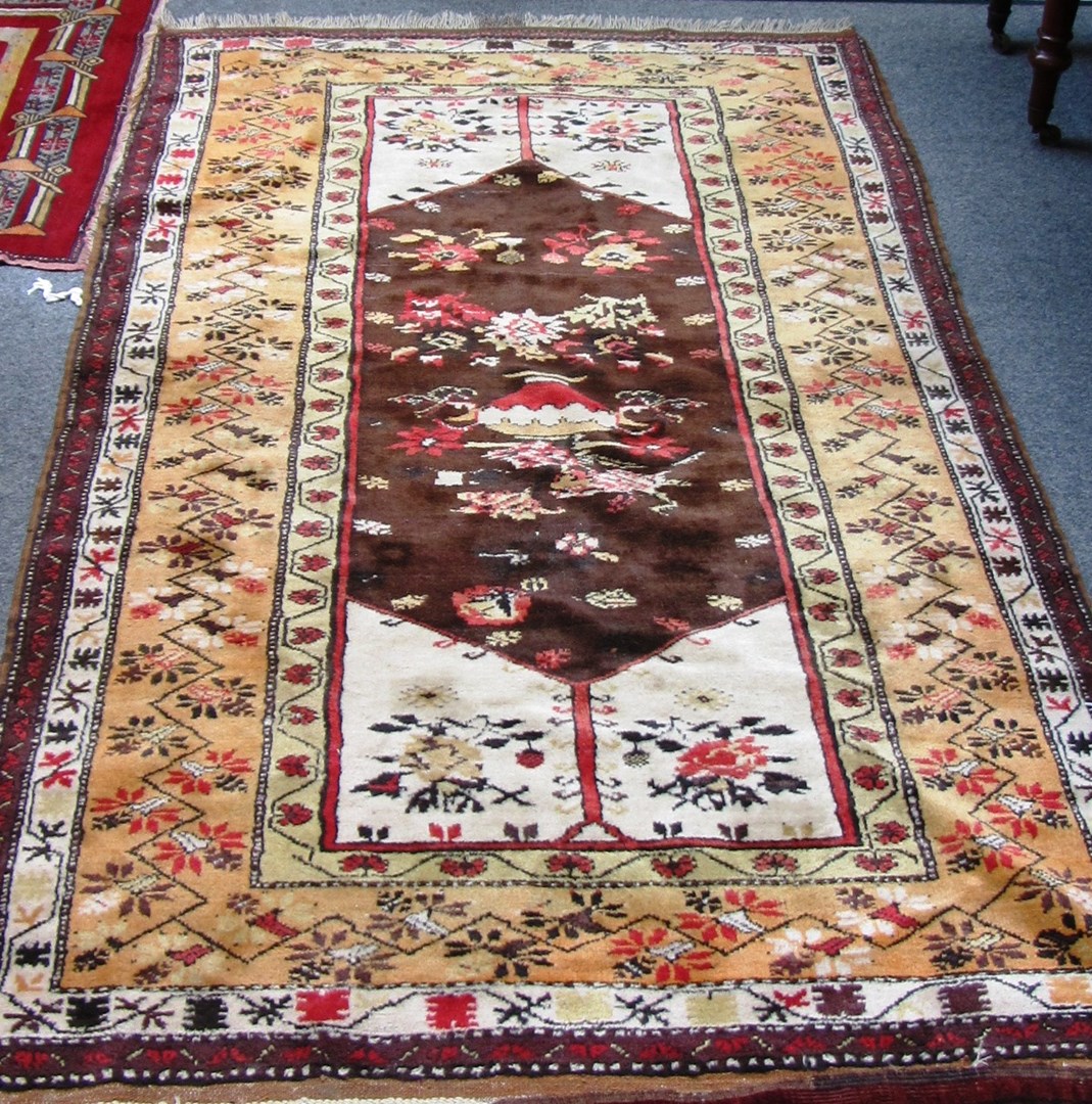 Appraisal: A Melas rug Turkish the brown field with flower filled