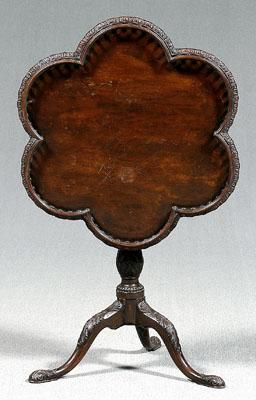 Appraisal: Chippendale mahogany tea table highly carved tilting shaped top with