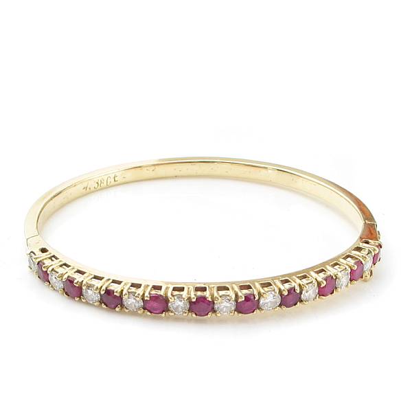 Appraisal: A diamond ruby and gold bangle estimated total diamond weight