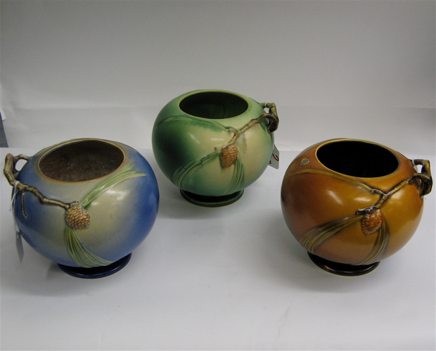 Appraisal: THREE ROSEVILLE POTTERY BOWLS in the Pinecone pattern green blue