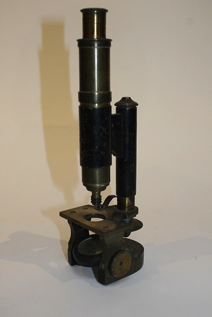 Appraisal: AN OLD BRASS MICROSCOPE on a shaped base and a