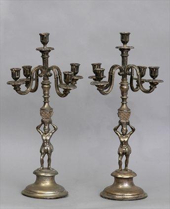 Appraisal: PAIR OF R GENCE STYLE SILVERED-METAL FIGURAL FIVE-LIGHT CANDELABRA Each