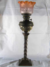 Appraisal: A large oil lamp with spiral brass column and brass