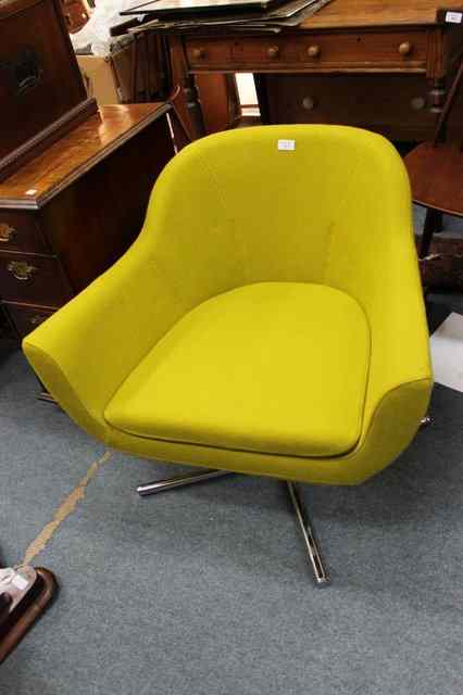 Appraisal: A 'S STYLE GREEN UPHOLSTERED SWIVEL ARMCHAIR on chrome support