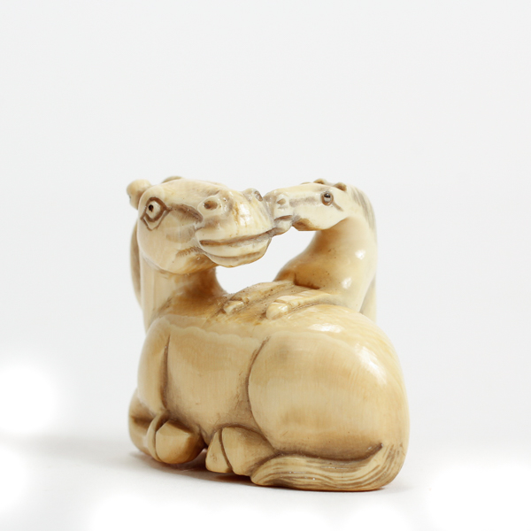 Appraisal: Japanese carved ivory horse and foal netsuke figure group signed