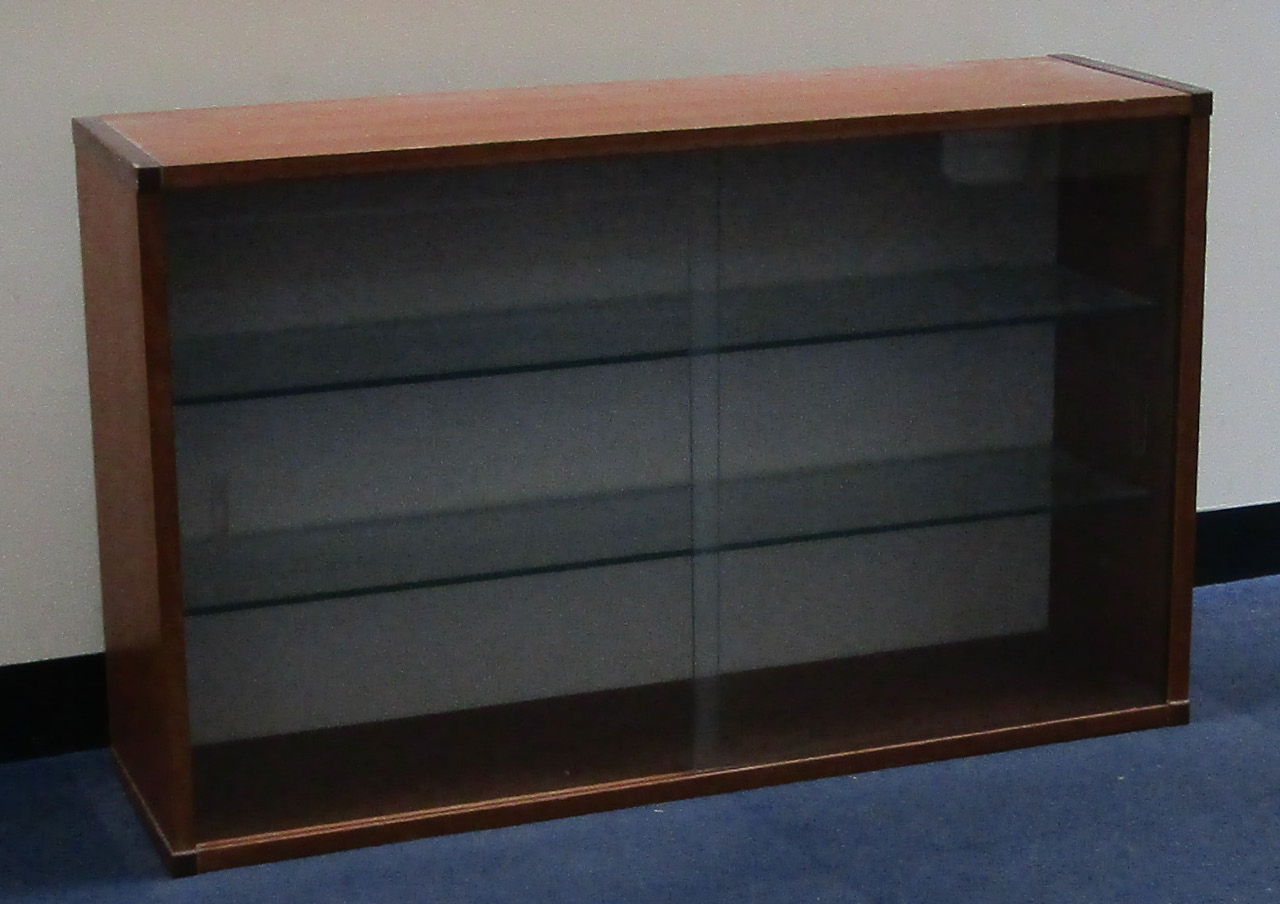 Appraisal: A teak display cabinet with two sliding glass doors enclosing