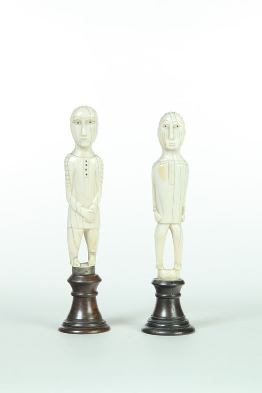 Appraisal: CARVED FIGURES Eskimo early th century walrus ivory Standing figures