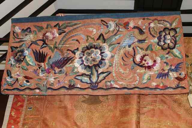 Appraisal: A CHINESE EMBROIDERED PANEL decorated with chrysanthemums peacocks and other