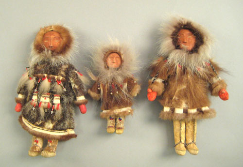 Appraisal: Three Northwest coast carved dolls with fur and beadwork dress