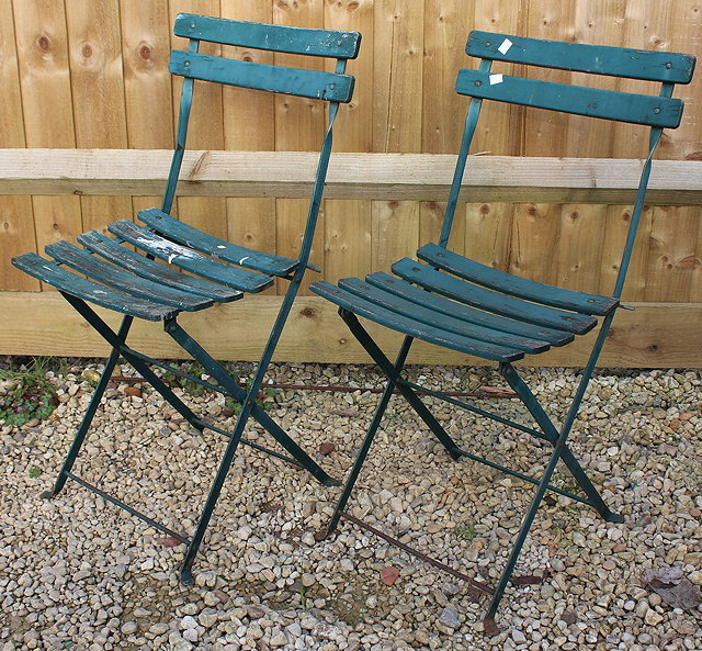 Appraisal: TWO GREEN PAINTED IRON AND WOODEN SLATTED FOLDING CAFE CHAIRS