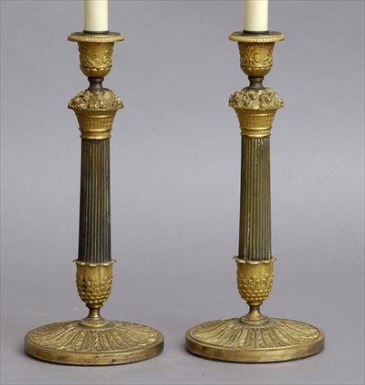 Appraisal: PAIR OF EMPIRE-STYLE BRONZE AND GILT-METAL CANDLESTICK LAMPS Each reeded