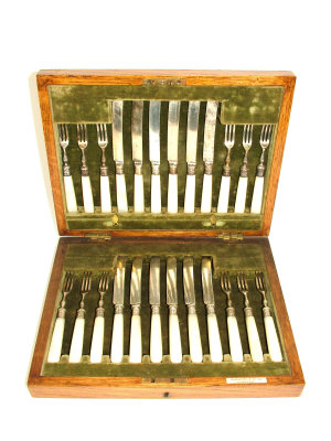 Appraisal: A set of twelve silver dessert knives and forks with