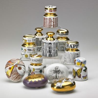 Appraisal: PIERO FORNASETTI Eight glazed ceramic insulator paperweights and four pebble