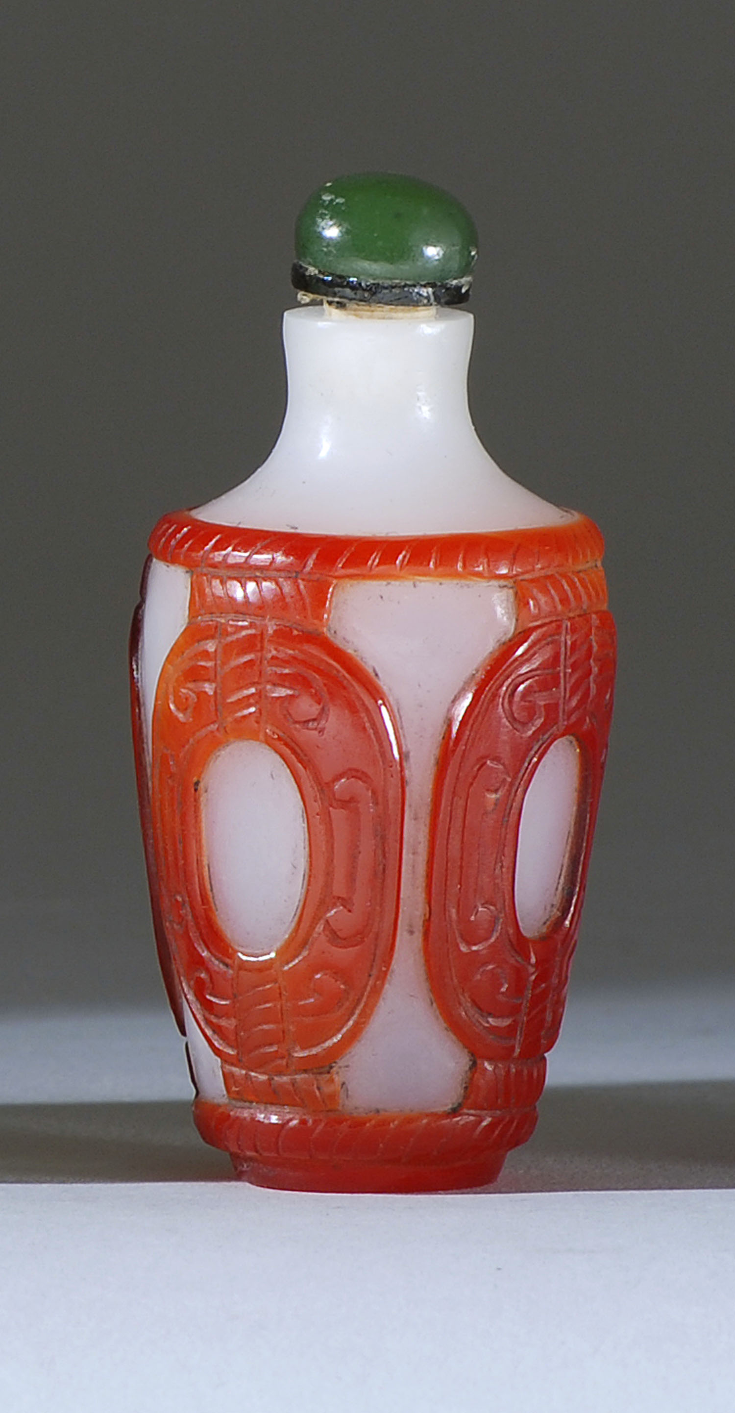 Appraisal: OVERLAY GLASS SNUFF BOTTLE Late th CenturyIn temple jar form