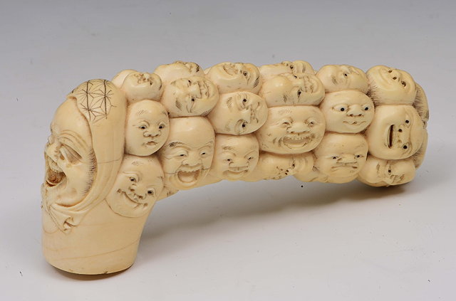 Appraisal: A Japanese carved ivory cane handleMeiji periodsigned in the form