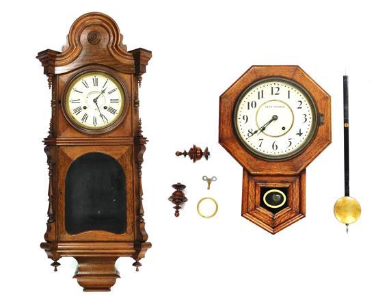 Appraisal: CLOCKS Two wall clocks the first Victorian walnut case turned