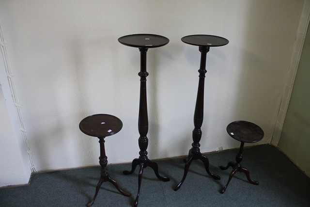 Appraisal: A PAIR OF MAHOGANY TORCHERES and two wine tables