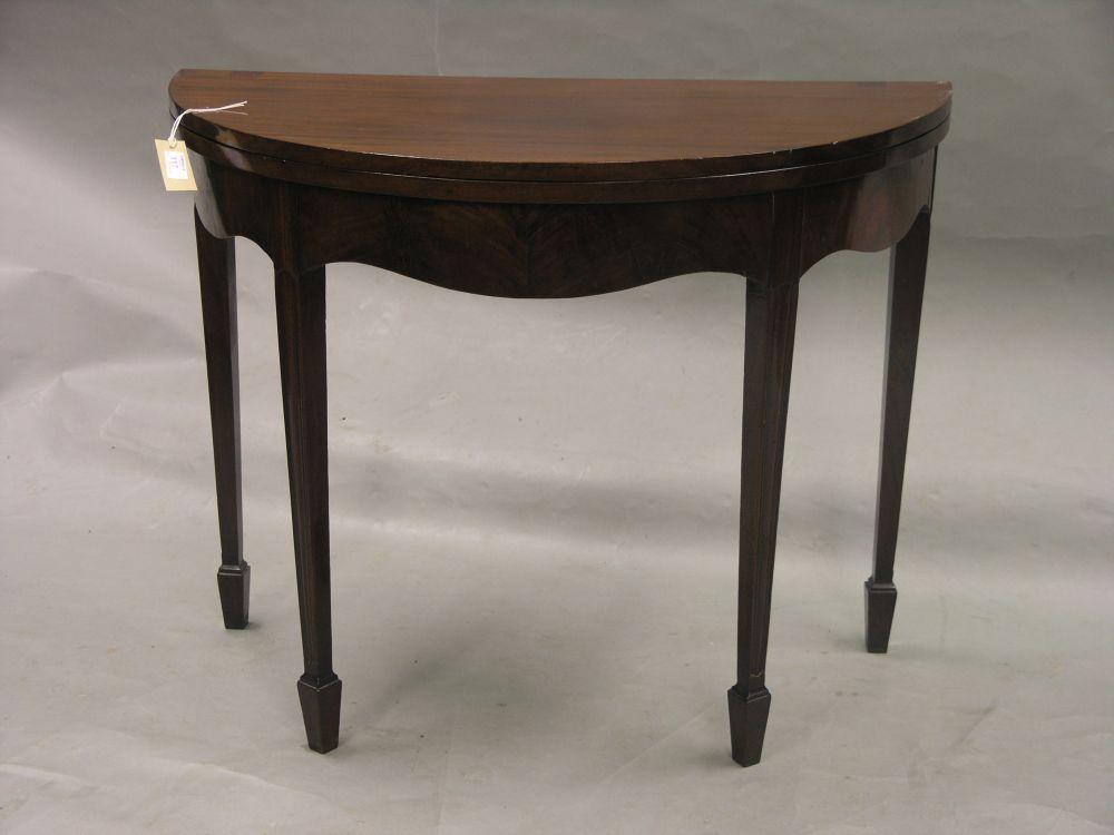 Appraisal: A late Georgian mahogany tea table half-round shape with folding