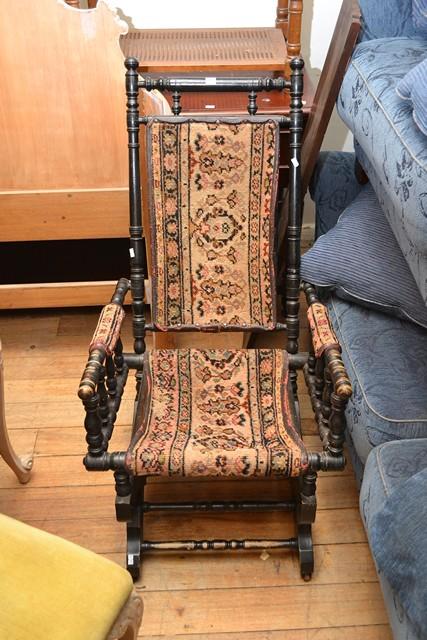 Appraisal: AN EBONISED PLATFORM ROCKER