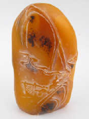 Appraisal: A Chinese orange hardstone engraved in bas relief with figures