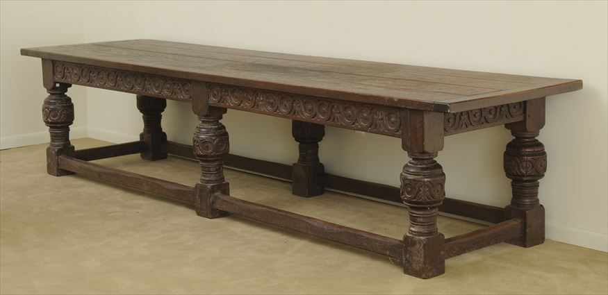 Appraisal: ELIZABETHAN STYLE CARVED OAK REFECTORY TABLE The four-plank top with