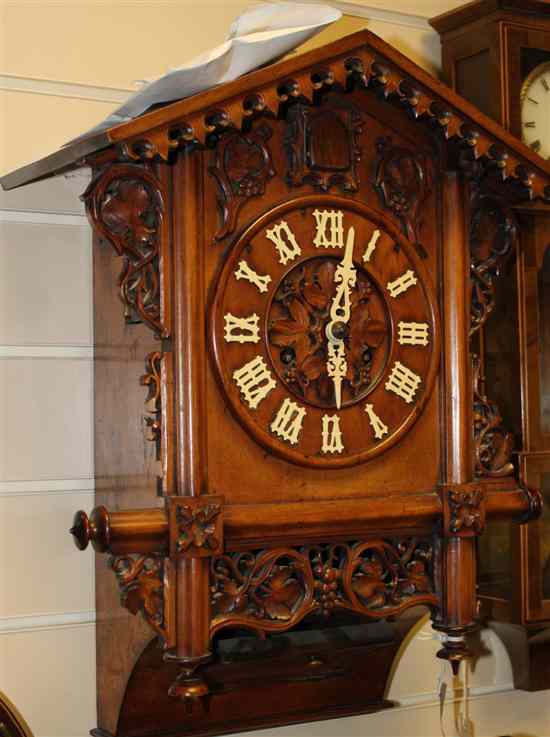 Appraisal: An early th century Black Forest walnut cuckoo clock with