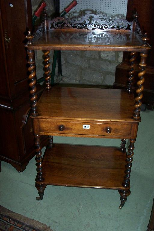 Appraisal: A Victorian walnut -tier whatnot fitted with a central drawer