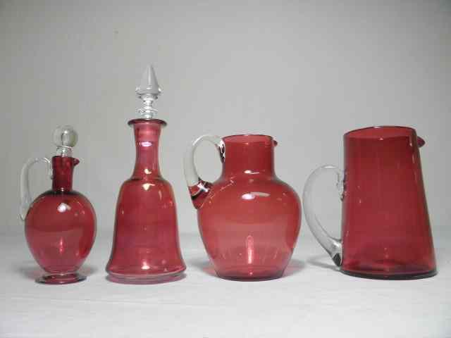 Appraisal: Lot of assorted cranberry glass pitchers decanter Includes a bulbous