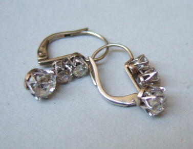 Appraisal: A pair of diamond set three stone pendant earrings each