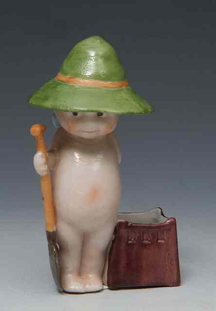 Appraisal: A porcelain figure of a young boy with gardening spade