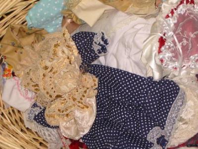 Appraisal: A basket of dolls' clothing in cotton silk and nylon