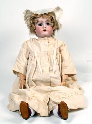 Appraisal: A German bisque head girl doll with brown glass sleeping