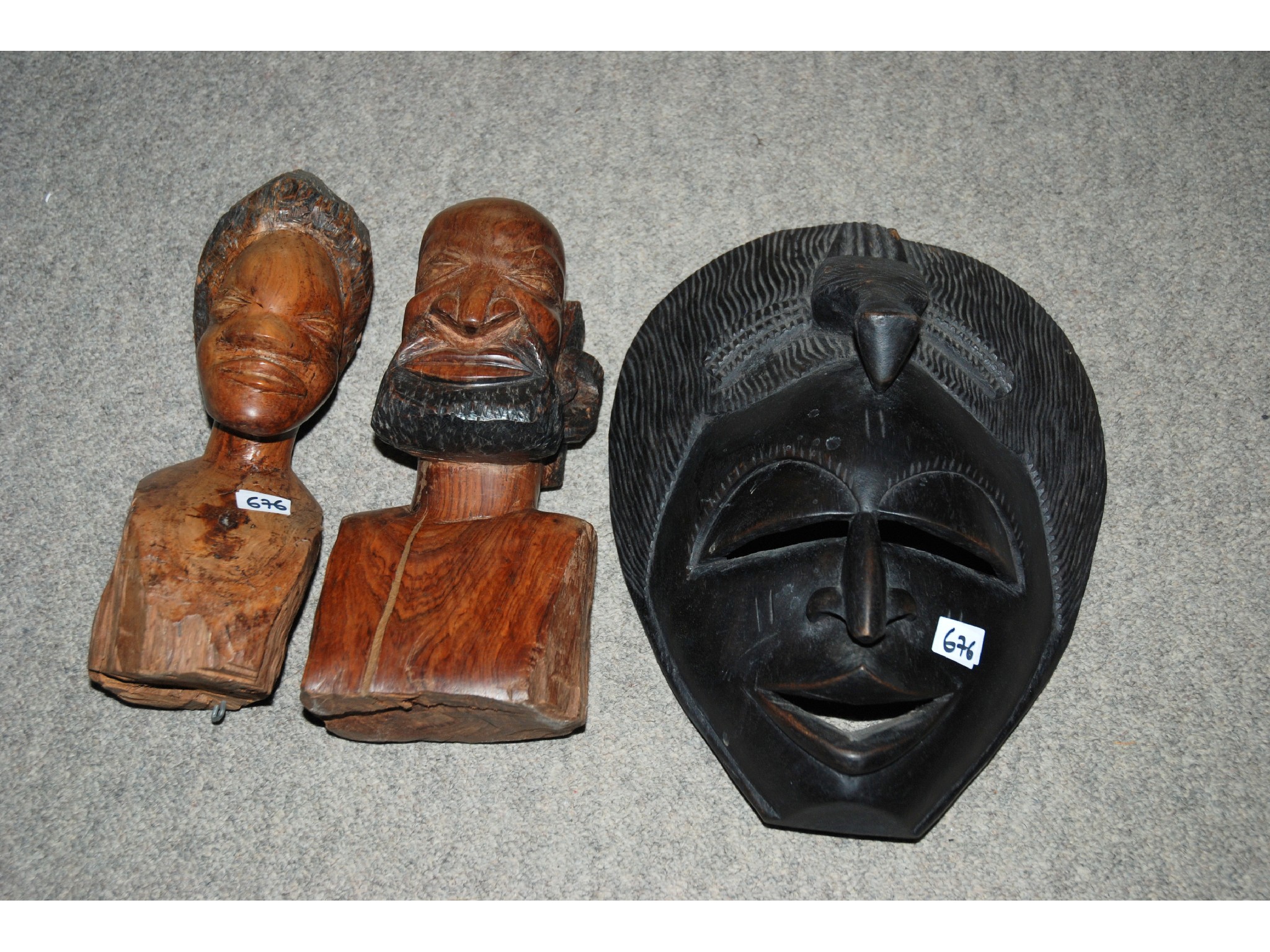 Appraisal: African carved wood mask two tall African figures and assorted