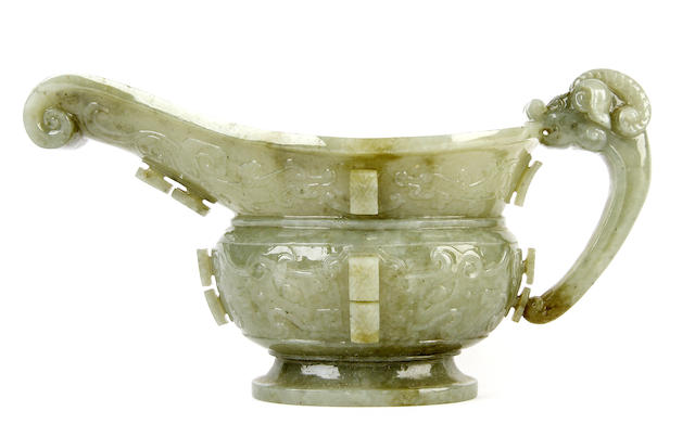 Appraisal: A Chinese pale green mottled jade sauceboat With a scrolled