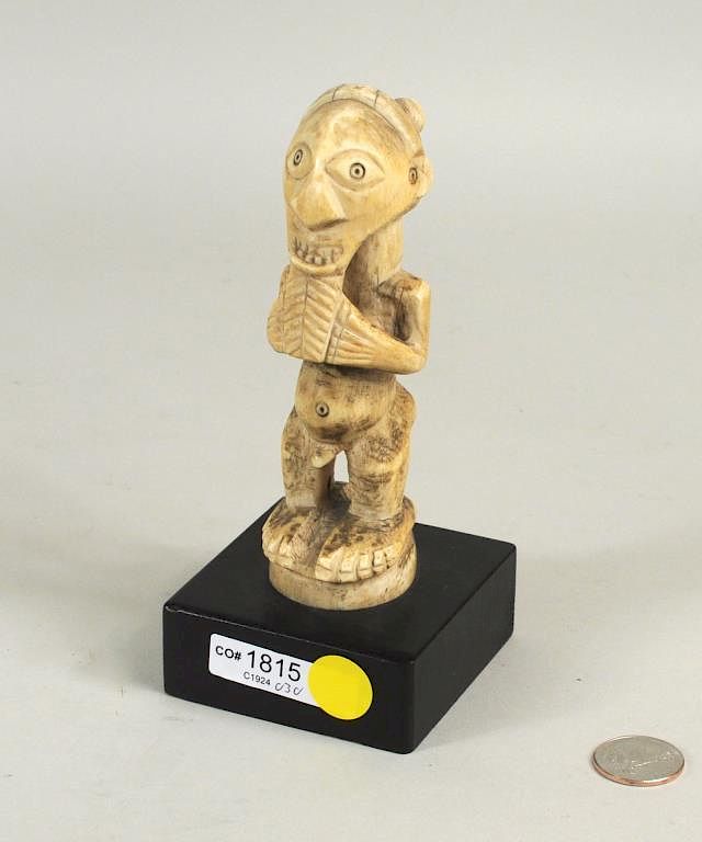 Appraisal: African Carved Bone Male Figure Wood Stand African carved bone