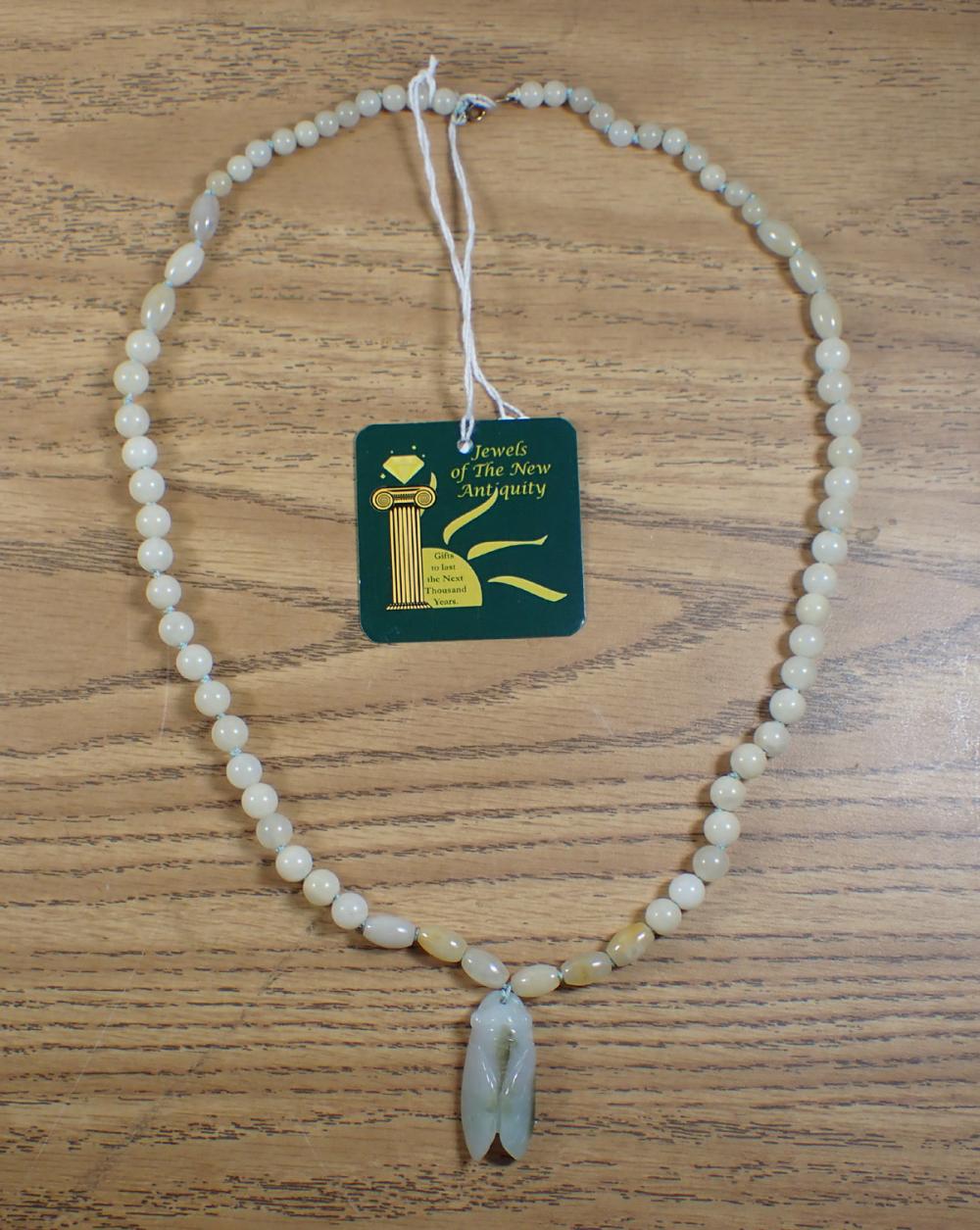 Appraisal: JADE AND FOURTEEN KARAT GOLD NECKLACE hand-knotted strand of light