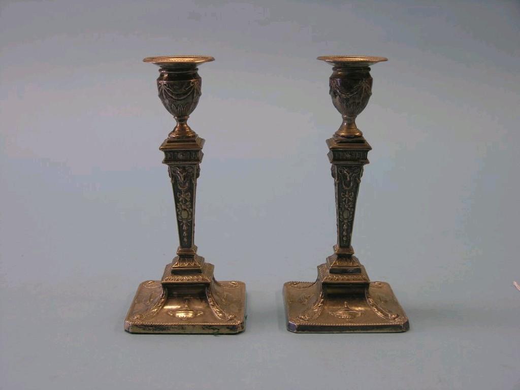 Appraisal: A pair of late Victorian silver candlesticks square tapering stems