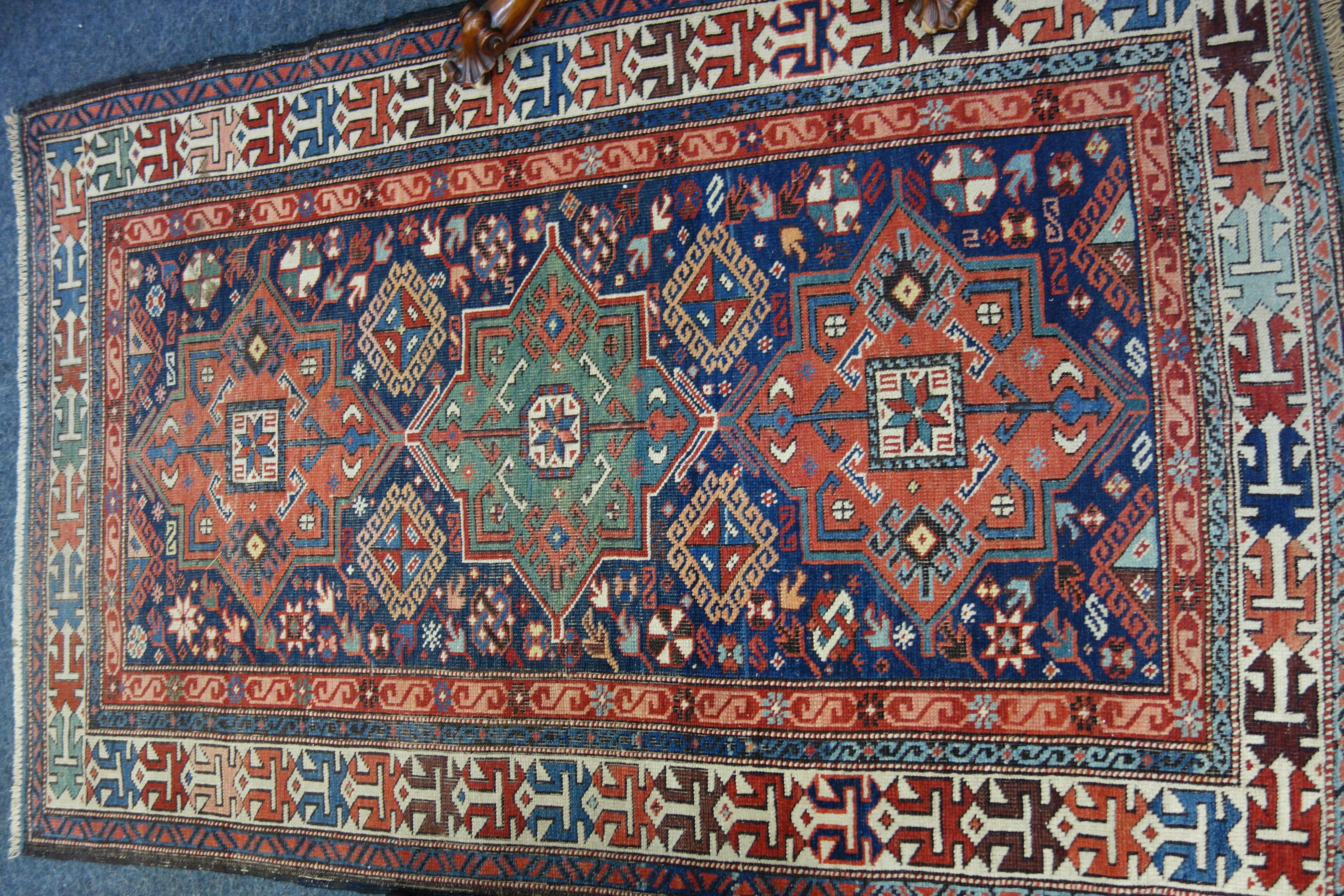 Appraisal: A Shirvan rug with star medallions on a blue field