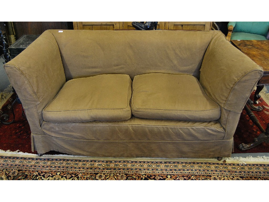 Appraisal: An Edwardian country house sofa with loose covers raised on