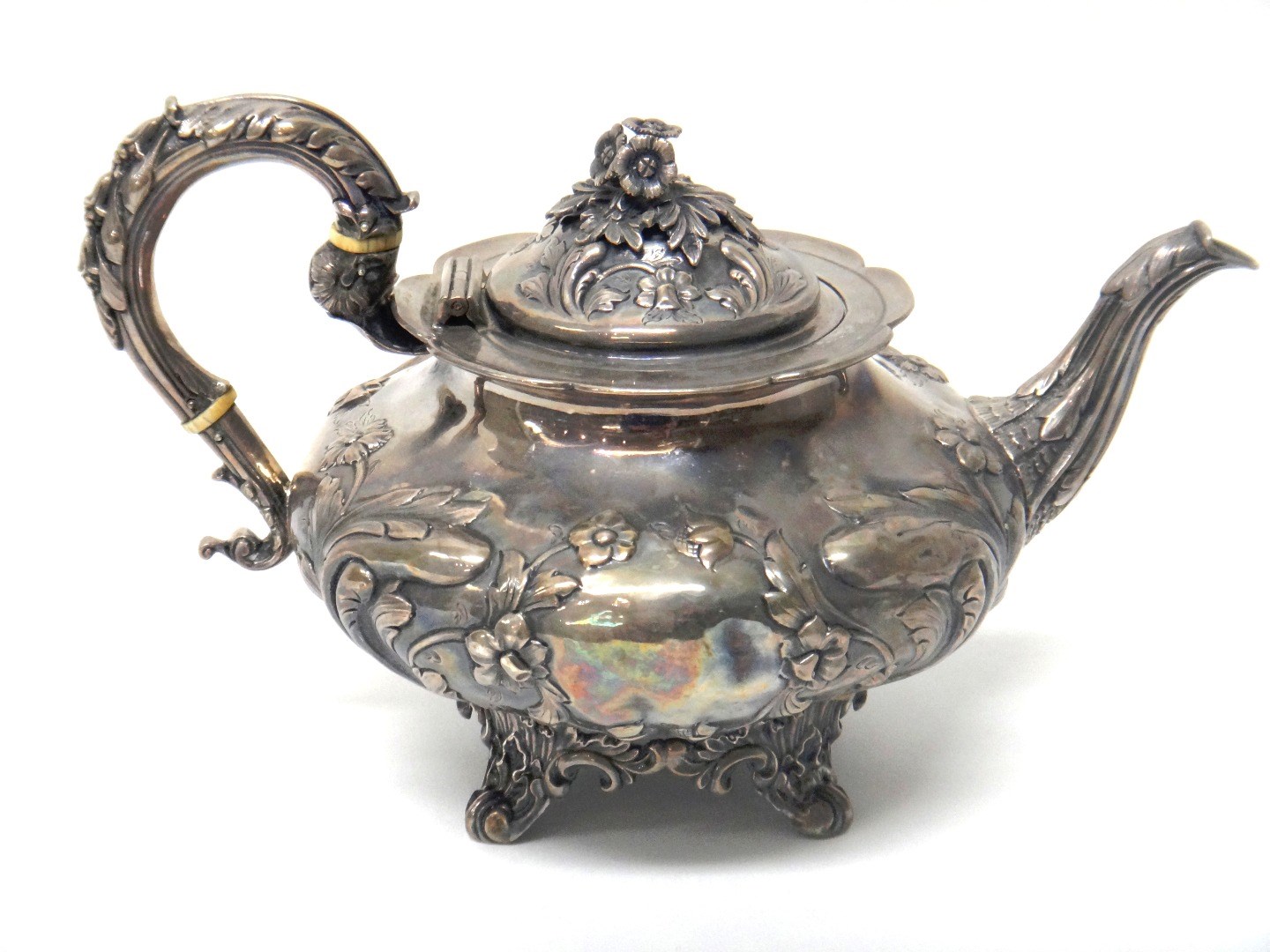 Appraisal: A Victorian silver teapot of squat melon form with embossed