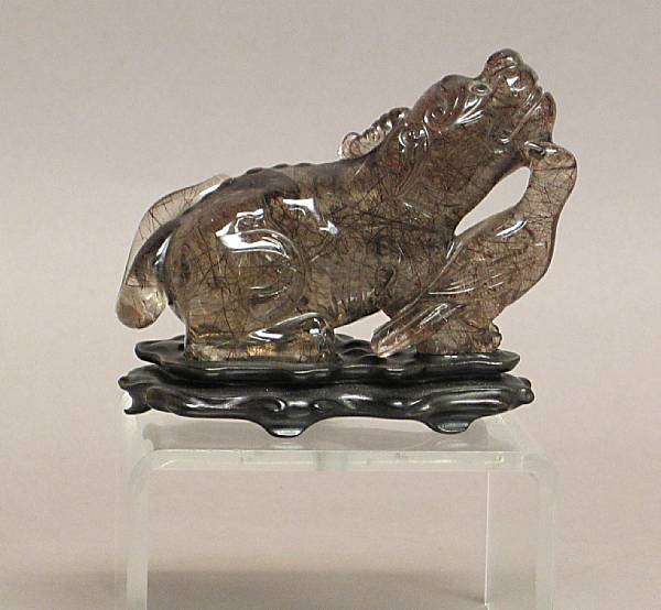 Appraisal: A rutilated quartz animal group Depicting a bird nestling next