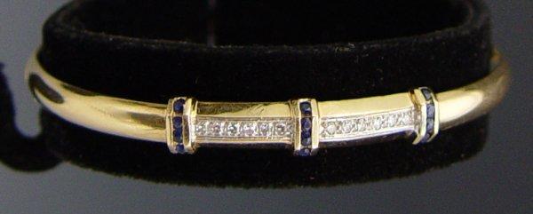 Appraisal: k DIAMOND AND SAPPHIRE BANGLE BRACELET K yellow gold hinged